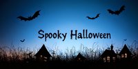 Dark silhouettes of houses and flying bats against deep blue night sky with spooky Halloween text, grass in foreground creates eerie atmosphere for seasonal design.