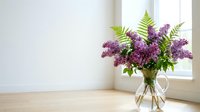 Fresh purple lilac bouquet with fern leaves in glass vase on wooden floor near bright window in minimalist white interior.