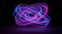 Glowing neon light trails in blue and magenta create an abstract orbital pattern against a dark background, suitable for modern design and digital projects.