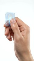 Hand using fingerprint scanner on futuristic transparent device with biometric authentication technology for security access control isolated on white.