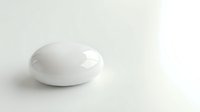 White oval soap bar on clean neutral background for skincare and hygiene product photography.