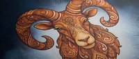 Ornate ram head with decorative swirls and patterns in warm bronze tones on textured background for zodiac and astrological designs.