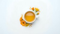 Overhead view of golden honey in white bowl surrounded by dried calendula flowers and petals on white background, isolated for design use.