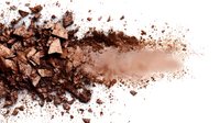 Crushed bronze eyeshadow powder with shimmer particles scattered on white background, creating gradient effect for makeup and cosmetics industry.