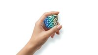 Young woman's hand holding a glowing neon circuit board chip with blue and green digital patterns against white background for technology and innovation concepts.