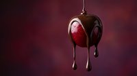 Fresh red strawberry covered in melted dark chocolate dripping down against burgundy background for dessert and confectionery advertising.