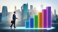 Businessman walking up colorful growth chart steps with city skyline background representing career advancement and business success progression.