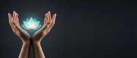Hands holding glowing turquoise lotus flower against dark background, symbolizing spiritual healing, wellness, and mindfulness for meditation and alternative therapy concepts.