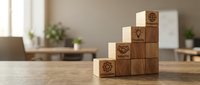 Wooden and white blocks stacked in pyramid formation with target icons, representing business growth, strategy and goal achievement on wooden desk.