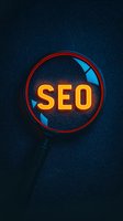Glowing SEO text through magnifying glass on dark textured background, neon orange letters with blue accents create dramatic lighting effect for marketing materials.