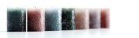Minimalist row of gradient colored candles arranged in fading perspective, creating atmospheric mood lighting effect with soft focus and selective depth of field.