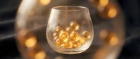 Glass filled with golden liquid and ice cubes, surrounded by warm bokeh lights, suitable for beverage, alcohol, and luxury drink advertising campaigns.