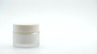 White cosmetic jar container with cream lid isolated on clean background for skincare product packaging and beauty brand marketing materials.