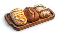Fresh artisanal bread loaves on wooden serving board, featuring rustic sourdough, dark rye, and tiger bread with distinctive scoring patterns and golden crusts.