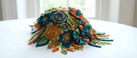Colorful embroidered textile art featuring vibrant orange, teal, and green floral motifs with dimensional thread work, isolated on white background for design projects.