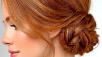 Elegant redhead woman with sophisticated braided updo hairstyle showcasing auburn hair texture and professional styling for beauty and fashion concepts.
