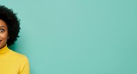 Young woman with curly dark hair and medium skin tone wearing bright yellow turtleneck against turquoise background, expressing surprise and joy for lifestyle and advertising campaigns.