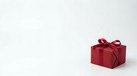 Red gift box with ribbon bow on white background, suitable for holiday, celebration, and retail marketing materials.