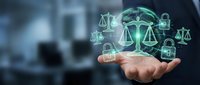 Businessman holding glowing digital globe with justice scales and padlock icons, symbolizing legal security and cyber law concepts.