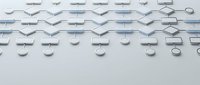 Modern geometric pattern with white circular and angular shapes creating rhythmic composition on light gray background for contemporary design projects.