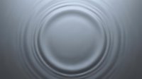 Concentric circular ripples emanating from central sphere on gray surface, creating abstract wave pattern for backgrounds and design projects.