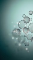 Transparent soap bubbles floating on soft teal gradient background with bokeh light effects for spa wellness and relaxation concepts.
