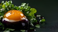 Sunny side up egg served on purple eggplant slice garnished with fresh microgreens and black sesame seeds against dark background, modern food styling.