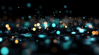 Dreamy bokeh lights in turquoise and golden colors create magical atmosphere on dark background. Abstract defocused glowing circles with blur effect for festive design.