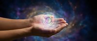 Hands cupped holding glowing circular energy symbol with cosmic nebula background for spiritual healing and meditation concepts.