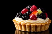 Gourmet fruit tart with fresh berries and cream on dark background for bakery menu, dessert photography, culinary advertising and food styling projects.