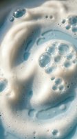Swirling foam bubbles in blue and white creating abstract patterns for skincare, cleaning products, soap, shampoo, cosmetics and hygiene marketing materials.