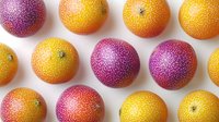 Fresh passion fruits in vibrant purple and yellow colors arranged in rows on white background, showing natural textured skin pattern and ripe tropical fruits.