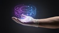 Caucasian hand holding glowing digital planetary system with orbital rings, representing technology, innovation, and futuristic concepts for business and science applications.