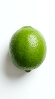 Fresh green lime with textured skin isolated on white background. Suitable for food, beverage, health, nutrition, cooking, and recipe content.