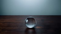 Clear glass crystal ball sphere sitting on dark wooden surface against blue gradient background for fortune telling and mystical concepts.