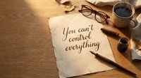 Handwritten motivational quote on vintage paper with coffee cup, glasses and pen on wooden desk for inspiration and mindfulness concepts.