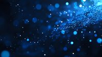 Glowing blue bokeh lights and particles floating in dark space create magical atmospheric effect with blurred sparkles and luminous dots scattered across background.