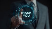 Businessman in suit touching futuristic holographic interface with glowing "THANK YOU" text against dark background, representing digital gratitude in corporate environment.