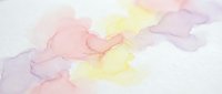 Soft watercolor background with pastel pink, yellow and purple hues blending together creating an artistic wash effect for creative projects and designs.