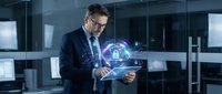 Businessman in dark suit and glasses holding tablet with glowing digital globe hologram, representing global connectivity, data networks, and international business technology solutions.