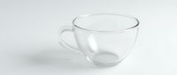 Empty transparent glass tea cup with handle isolated on white background for beverage and kitchen design projects.