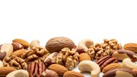Mixed nuts collection with almonds, walnuts, pecans and cashews on white background isolated for healthy snacking and cooking designs.