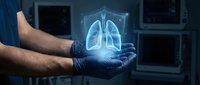Young adult male healthcare professional wearing blue medical gloves holding glowing digital lungs hologram in modern hospital setting with monitors in background.