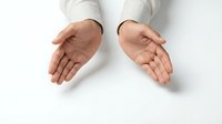 Professional man in white shirt extending open palms in welcoming gesture showing trust and openness for business presentations and communication concepts.