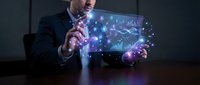 Professional businessman analyzing holographic financial data and charts with futuristic technology interface for business analytics and forecasting.