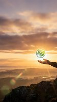 Hand holding renewable energy icon above landscape with wind turbines and solar panels at sunset, symbolizing sustainable development and green technology solutions for environmental conservation.