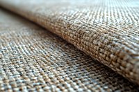 Natural burlap fabric close up with selective focus showing woven texture and pattern, rough organic material in beige and brown tones for background design.