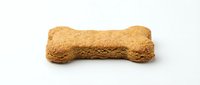 Dog bone-shaped treat or biscuit with textured golden-brown surface on white background, suitable for pet food packaging, veterinary materials, and animal care marketing.