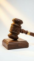 Ornate wooden judge gavel with decorative carved details on sound block against soft neutral background for legal and justice concepts.