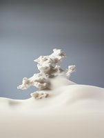 Abstract white fluid sculpture with organic flowing shapes against neutral gray background creates minimalist artistic composition for modern interior design.